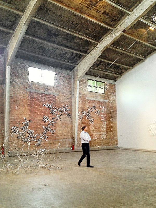 Man walks through an art installation.