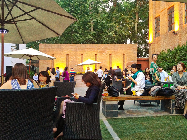 People hang out at the Grace Hotel gardens for a drink at the sun set.