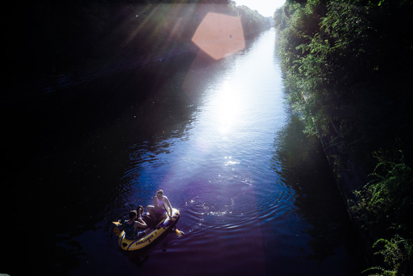 People rowing a air-boat on a river in Berlin.