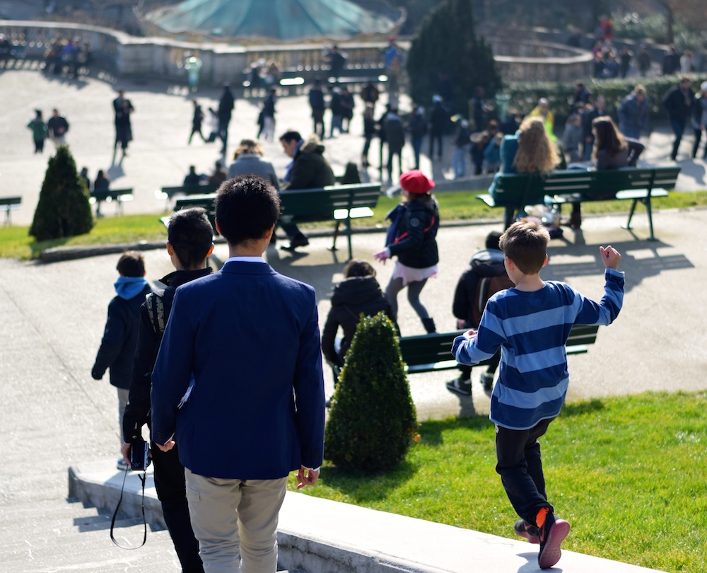 Photo of a boy running near the Montmartre in Paris.