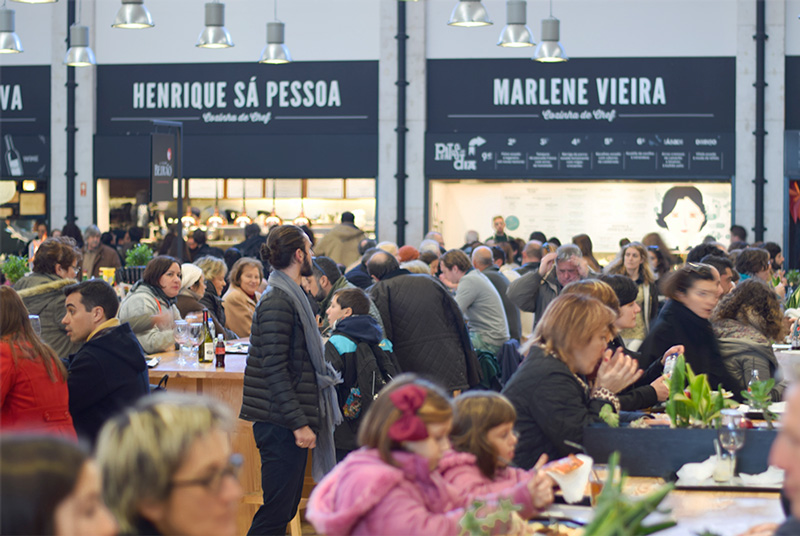 People of Lisbon Portugal eating inside Mercado da Ribeira