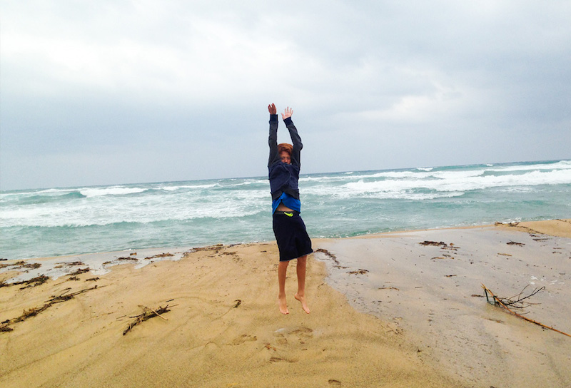 Travel photo of a teenager jumping on the beach after a storm in Cabo de Gata on southeastern Spain's wild coastline