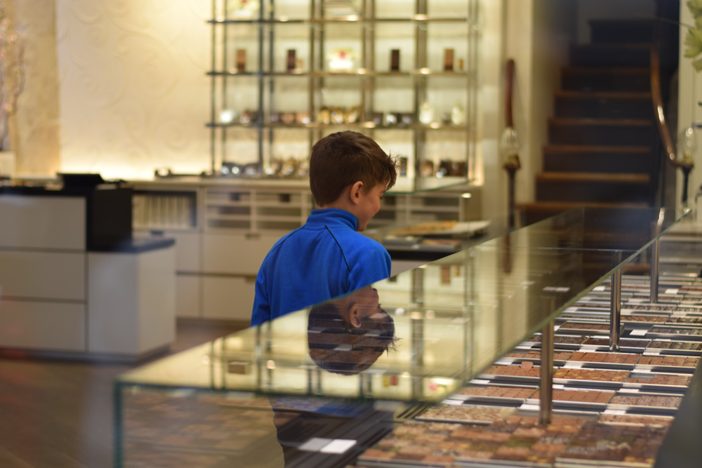 A boy selecting chocolates in Jaques Genin, Paris.