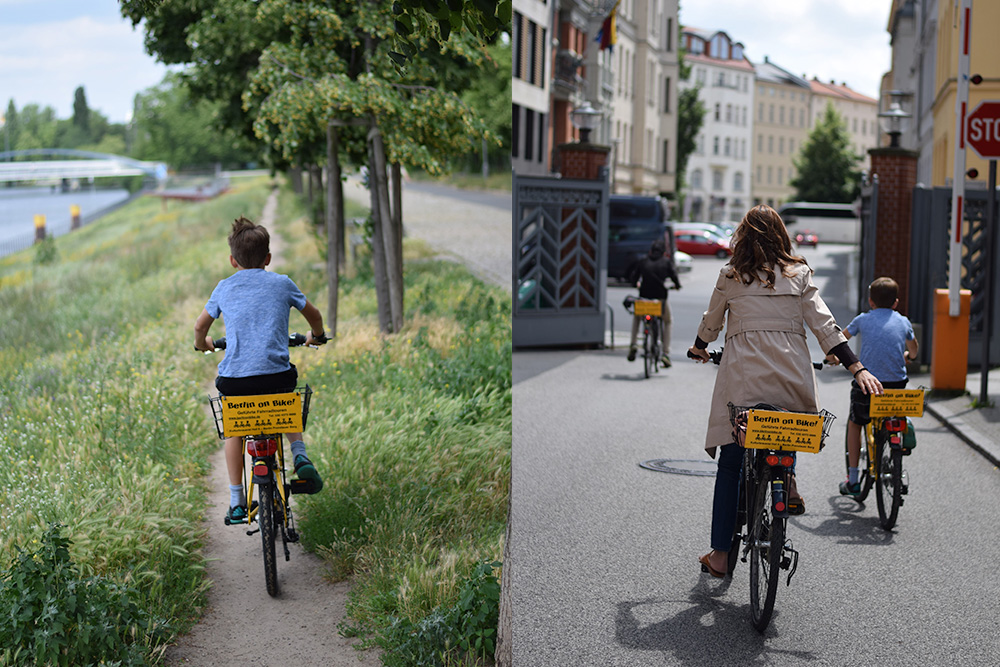 A photo of a boy riding a bike on a dirt path near the Spree River in Berlin, Germany. A photo of a mother and children on a bike tour of the Berlin Wall.