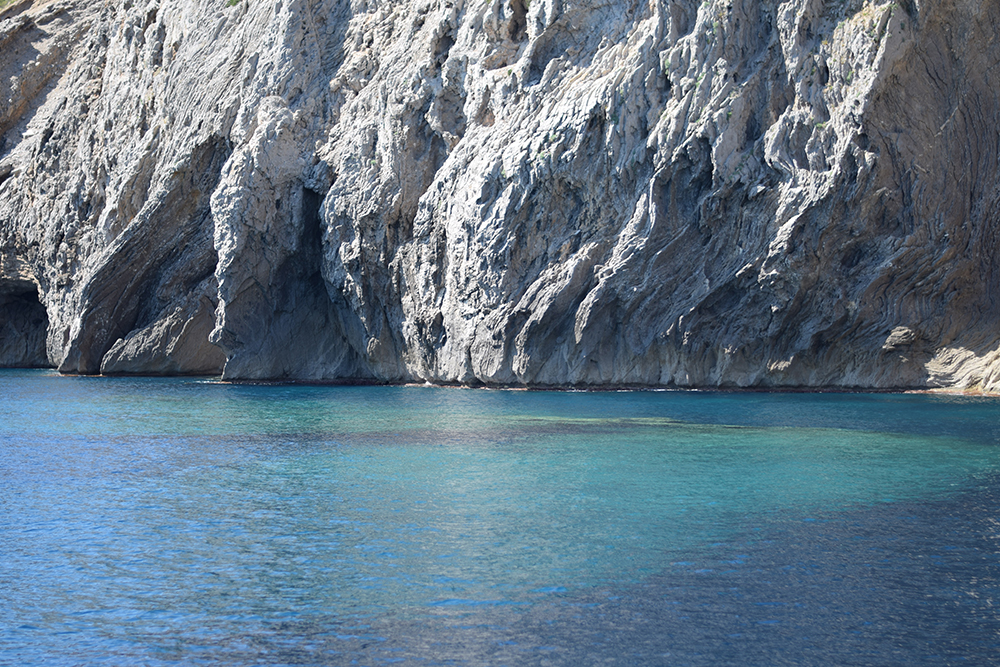 A photo of beautiful blue waters and white cliffs in Cap Formentor, Mallorca, Spain.