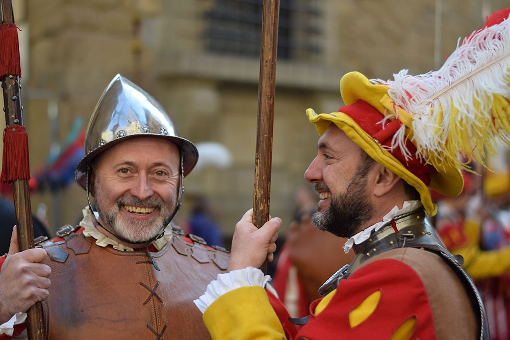 A photo of two men smiling in period costume during an Easter celebration in Florence, Italy