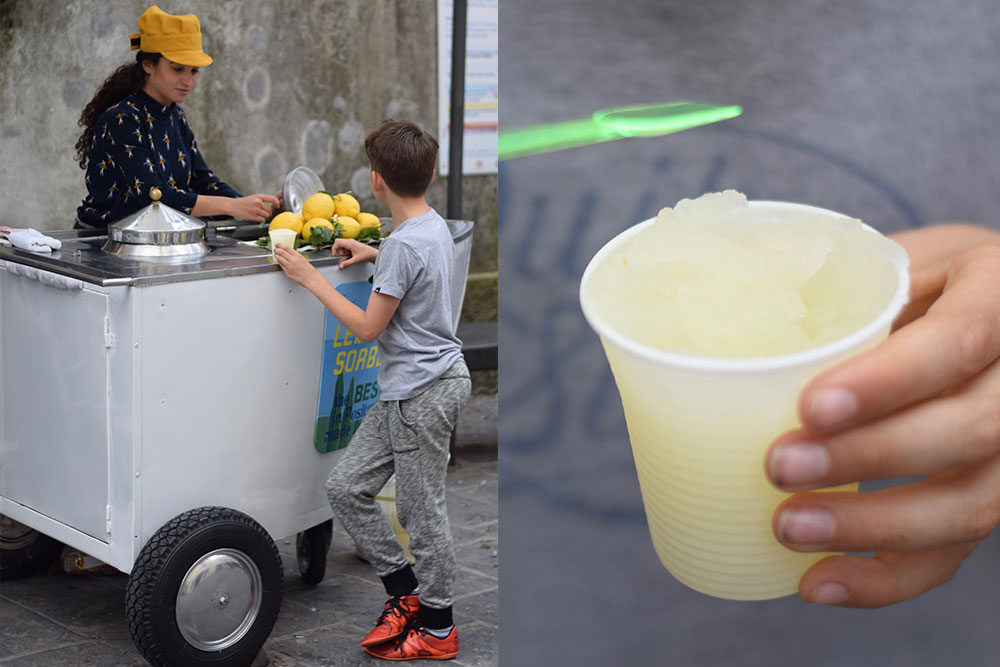 Photo of a boy buying fresh iced lemonade from a seller in Positano, Italy.