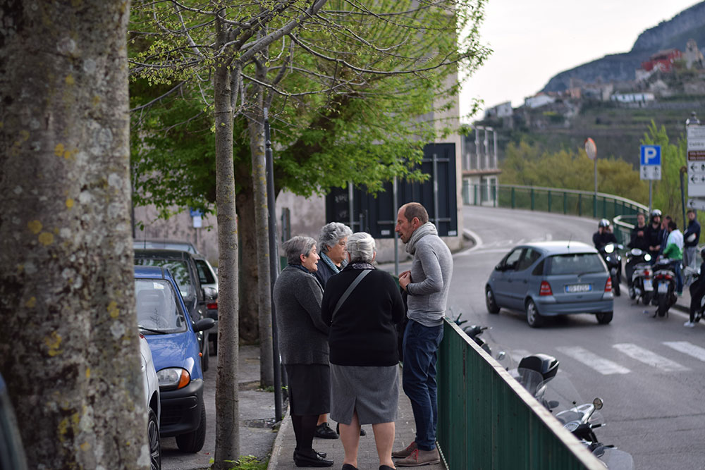 Photo of local people of Ravello, Italy chatting; 3 older women and a man.