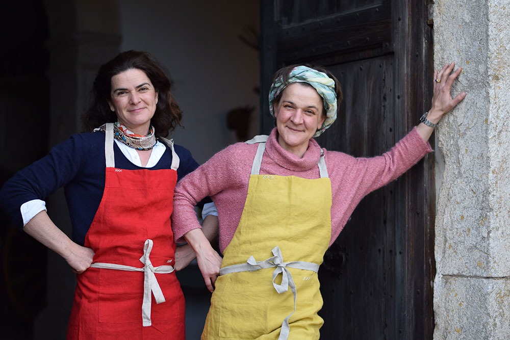 Two sisters standing at the entrance to a farmhouse called Finca Son Mico in Soller, Mallorca, Spain.