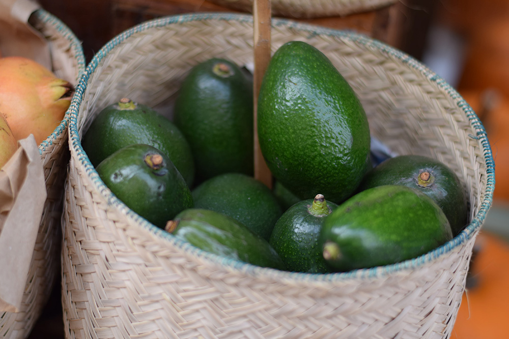 Photograph of a basket of avocados at the Santa Maria market in Mallorca, Spain.