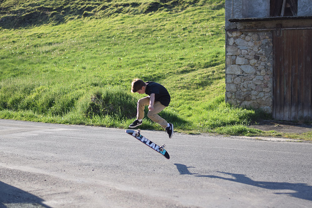 Photo of a boy jumping on his skateboard in rural France.