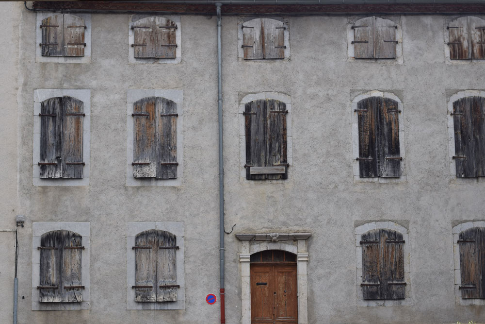 Photo of the exterior of an old building in the a village in rural France.