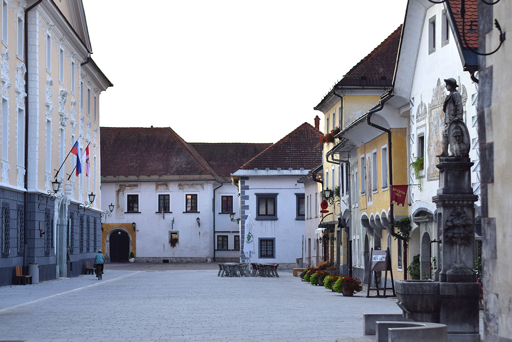 Photo of a plaza lined with colorful buildings in the small town of Radovljica, Slovenia.