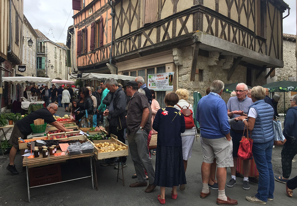 Photo of people at a market in France.